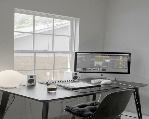 Minimalist work desk setup with notebooks and ambient lighting